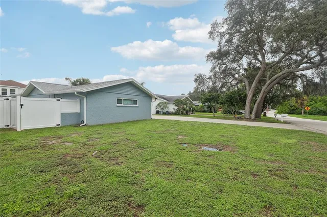 a view of an house with backyard space and garden