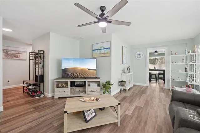 a living room with furniture and a wooden floor