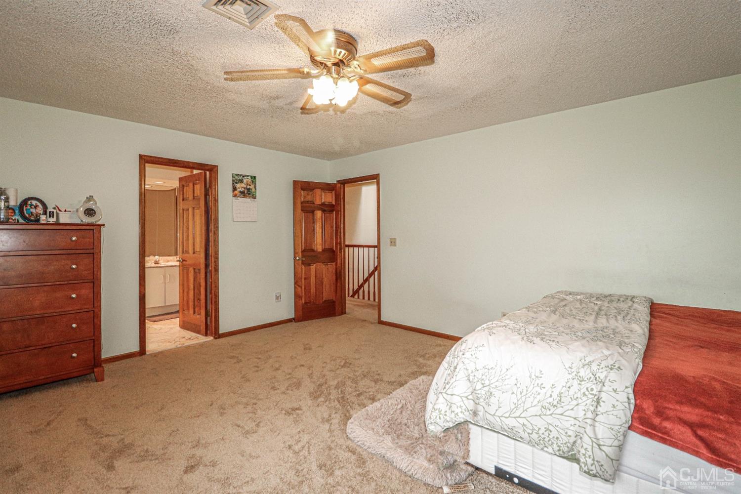 15 Skytop Road Edison, NJ 08820 - Photo 17 of 29 a view of a bedroom with a dresser and chandelier