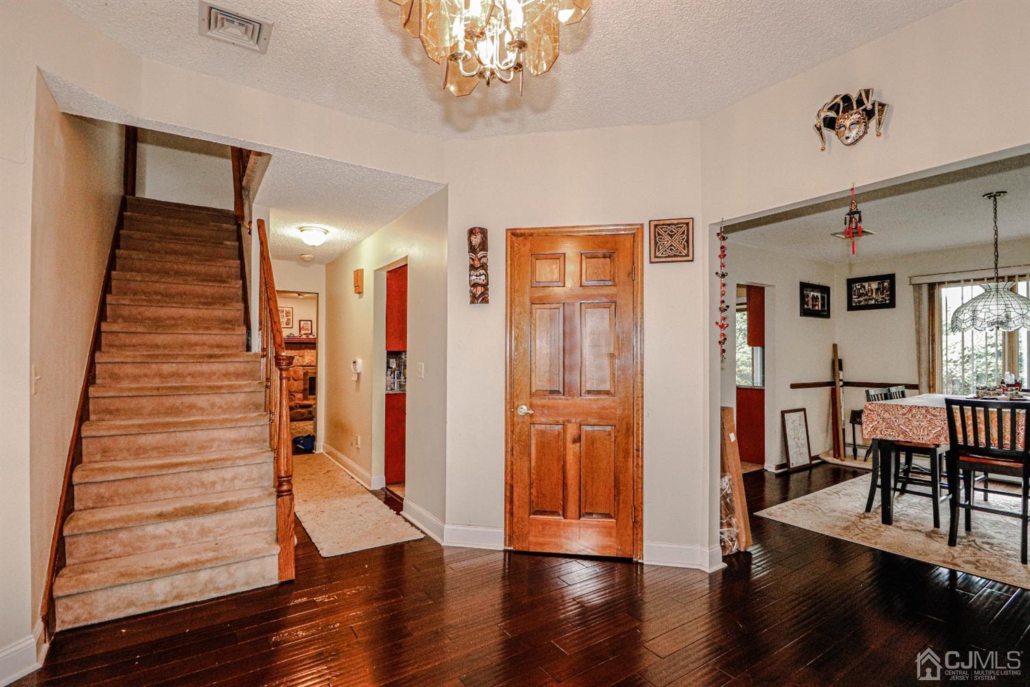 15 Skytop Road Edison, NJ 08820 - Photo 3 of 29 a view of a hallway with wooden floor and staircase