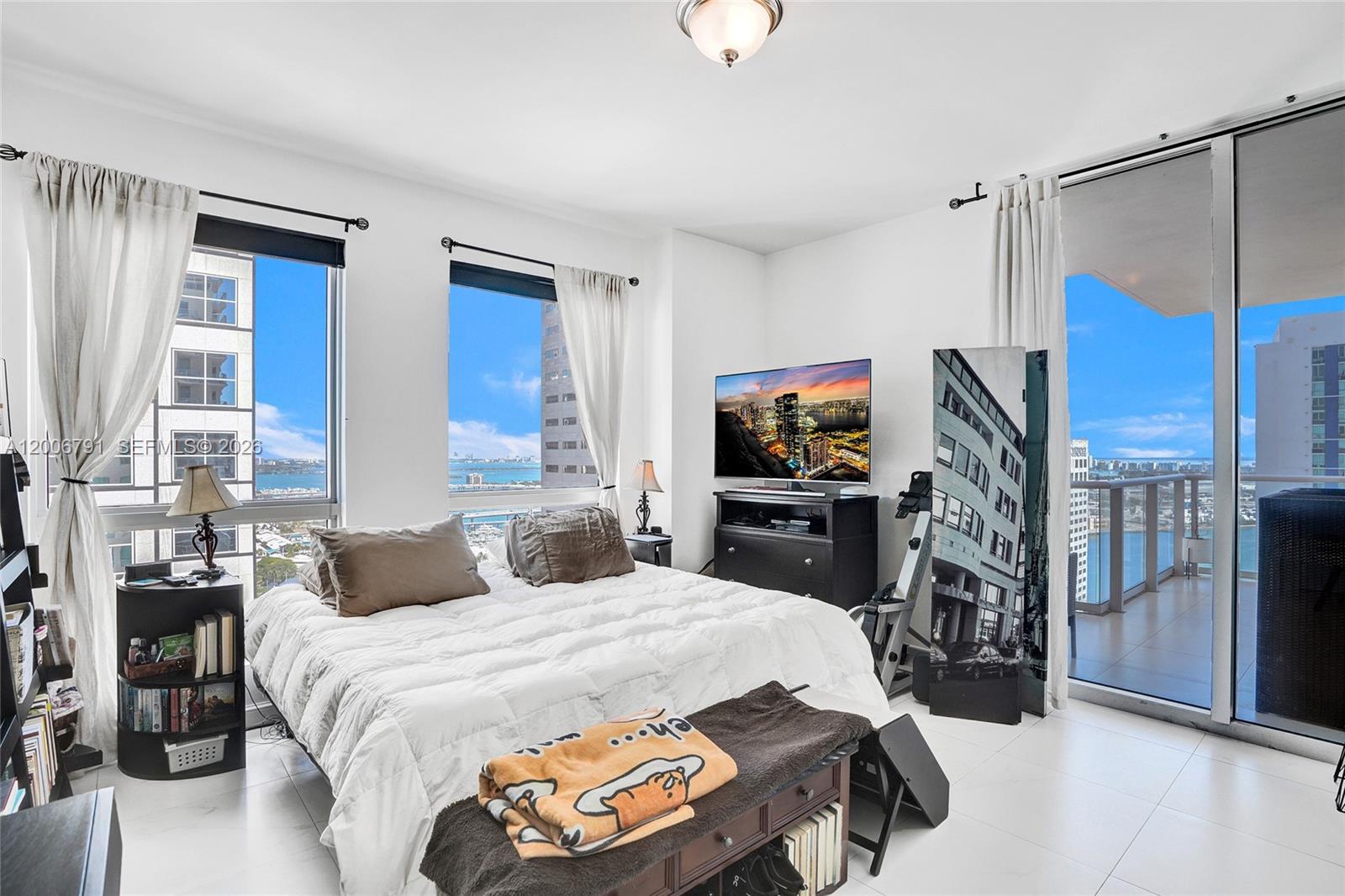 300 South Biscayne Boulevard, Unit T3216 Miami, FL 33131 - Photo 5 of 11 a bedroom with a bed a flat screen tv and dresser