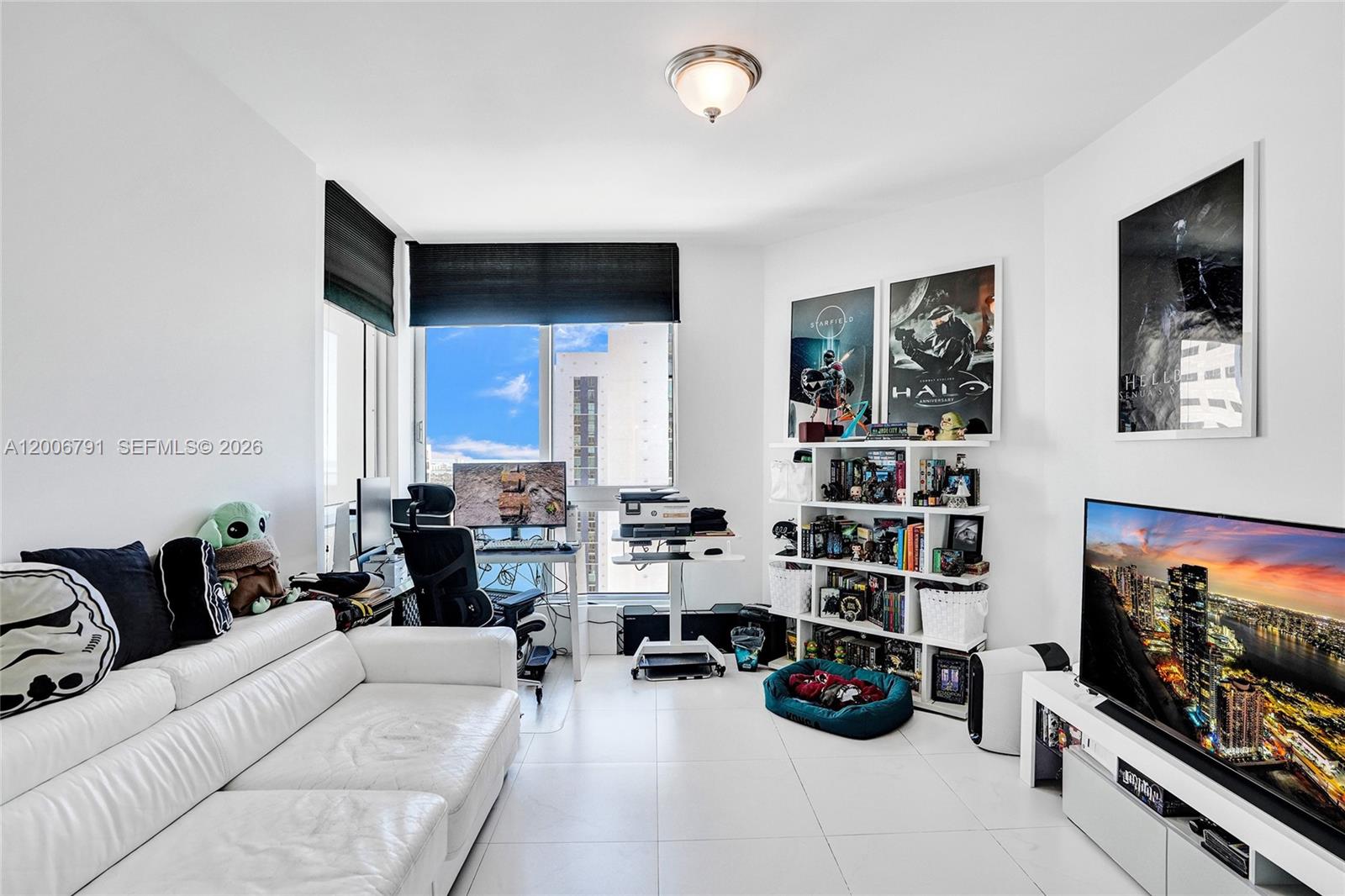 300 South Biscayne Boulevard, Unit T3216 Miami, FL 33131 - Photo 8 of 11 a living room with furniture and a flat screen tv