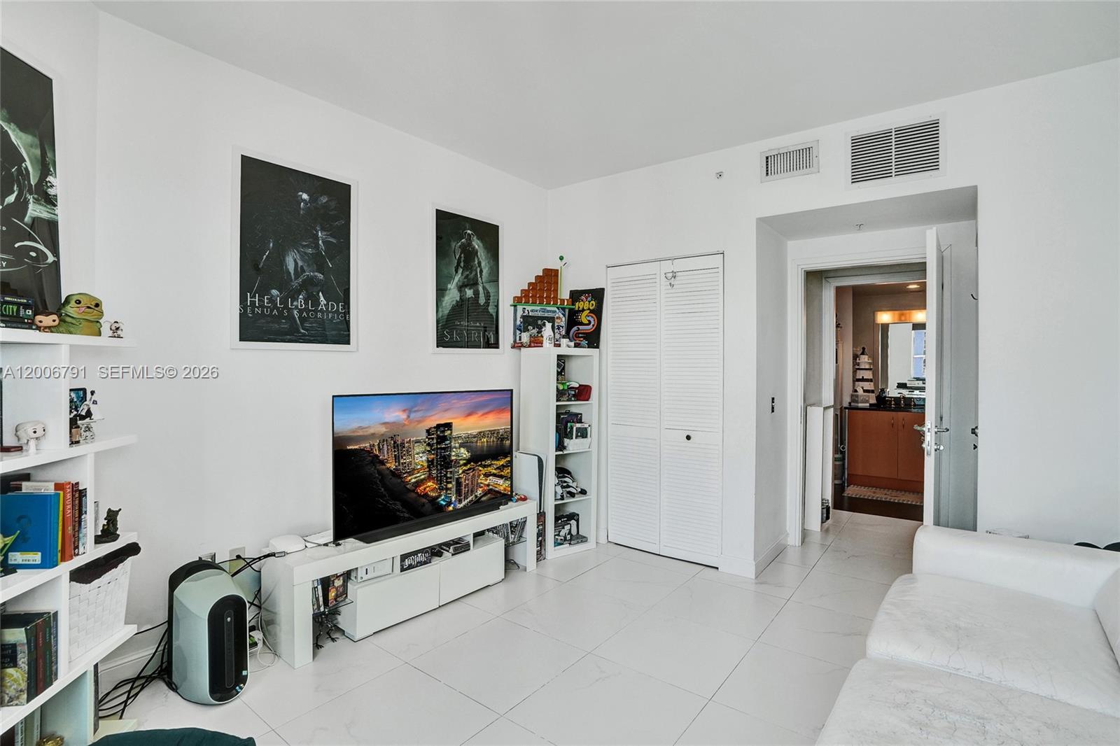 300 South Biscayne Boulevard, Unit T3216 Miami, FL 33131 - Photo 9 of 11 a living room with furniture and a flat screen tv
