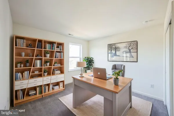 a living room with furniture and a book shelf