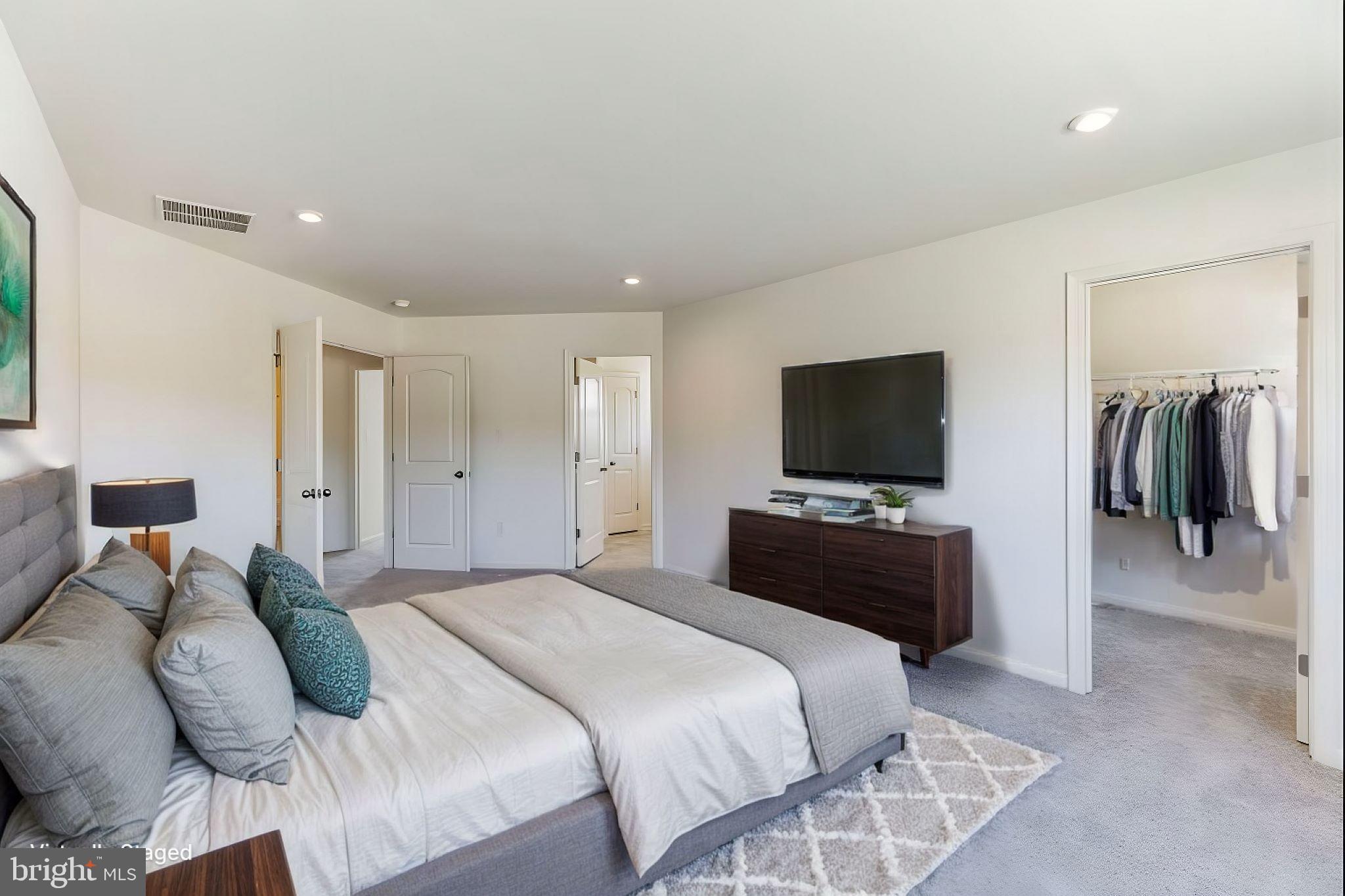 180 Locktown Sergeantsville Road Stockton, NJ 08559 - Photo 18 of 27 a bedroom with a bed and a flat screen tv