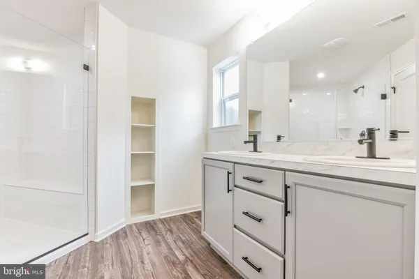 a bathroom with a double vanity sink mirror and