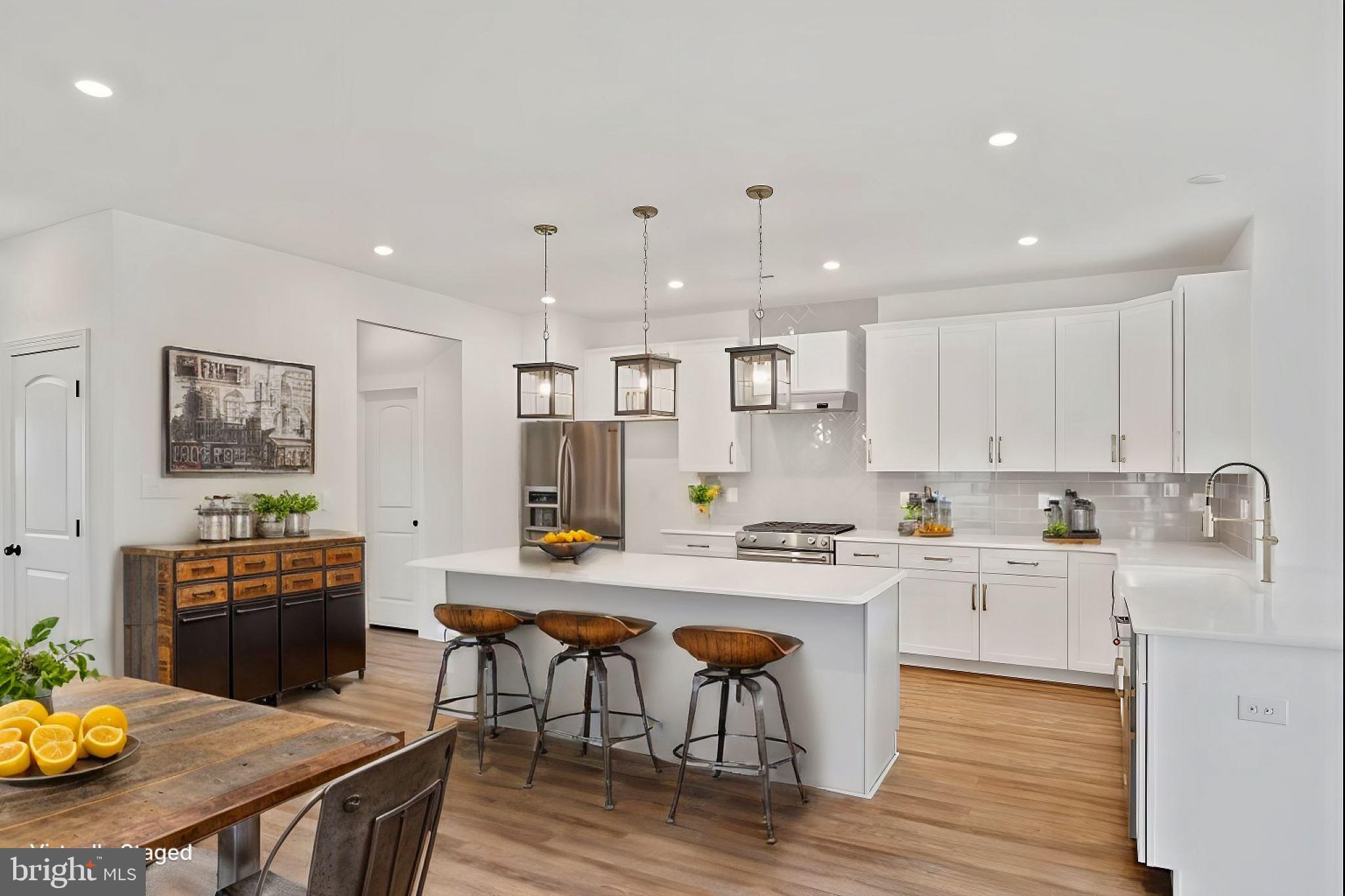 180 Locktown Sergeantsville Road Stockton, NJ 08559 - Photo 6 of 27 a kitchen with stainless steel appliances granite countertop a stove top oven a sink a refrigerator white cabinets and wooden floor