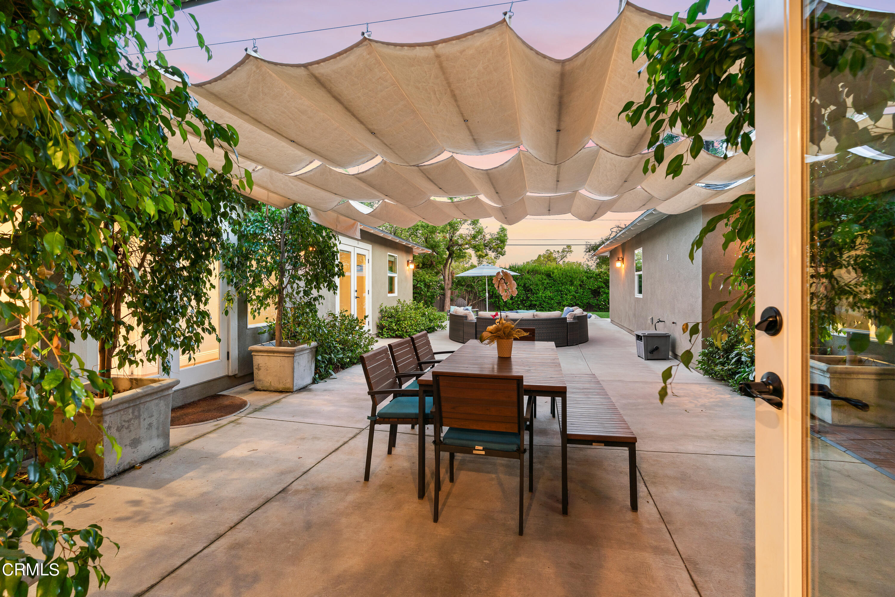 3760 Hampton Road Pasadena, CA 91107 - Photo 20 of 22 a view of a patio with a table and chairs and potted plants