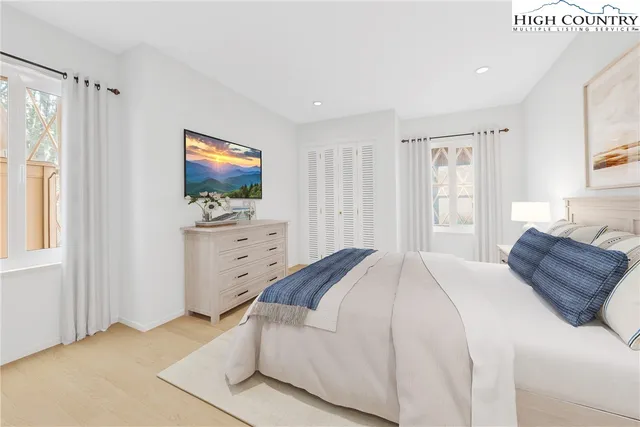 a bedroom with a bed and a television