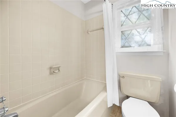 a spacious bathroom with a sink mirror and tub