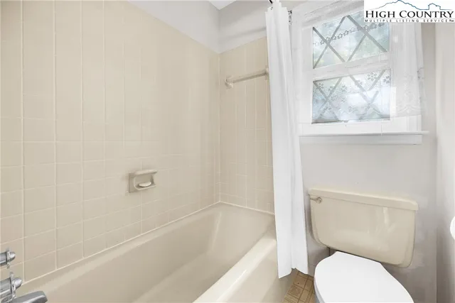 a spacious bathroom with a sink mirror and tub