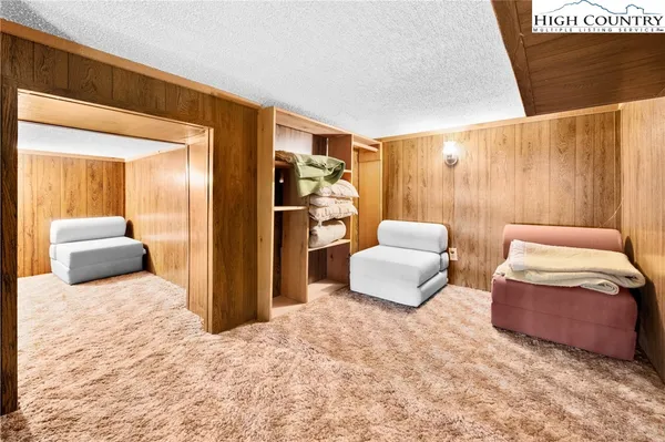 a living room with furniture a fireplace and large windows