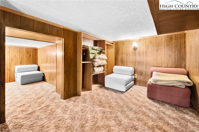 a living room with furniture a fireplace and large windows