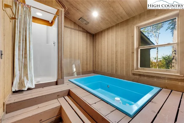 a bedroom with two beds and a window