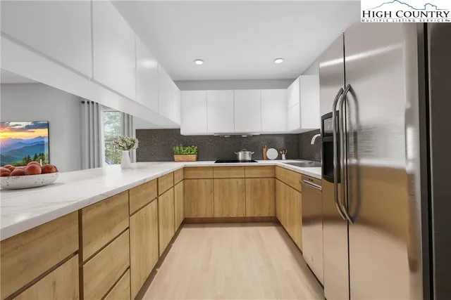 a kitchen with refrigerator and window