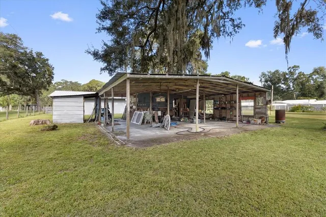 an aerial view of a residential houses with outdoor space and street view