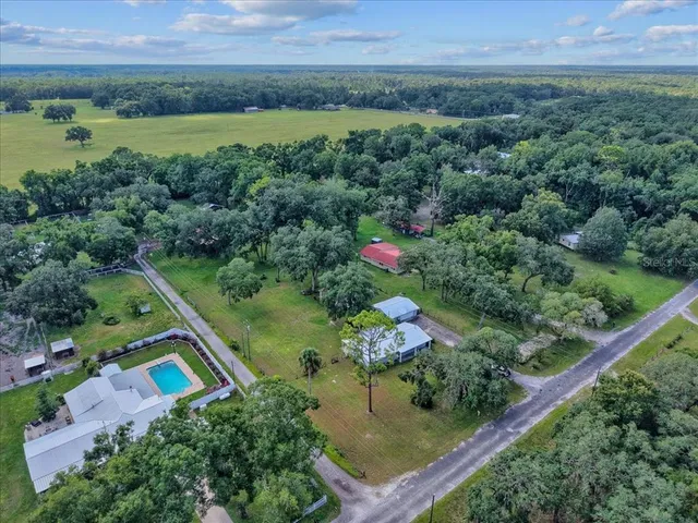 an aerial view of residential house with outdoor space and swimming pool