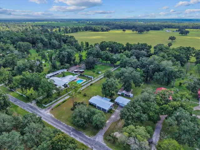 a aerial view of a house with a yard
