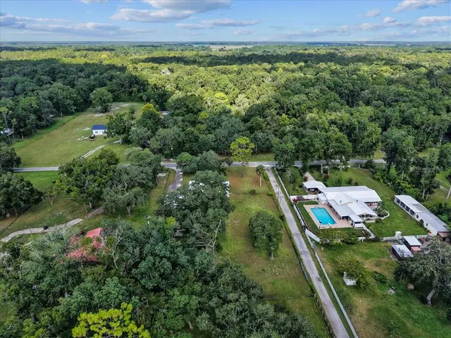 an aerial view of a house with a yard