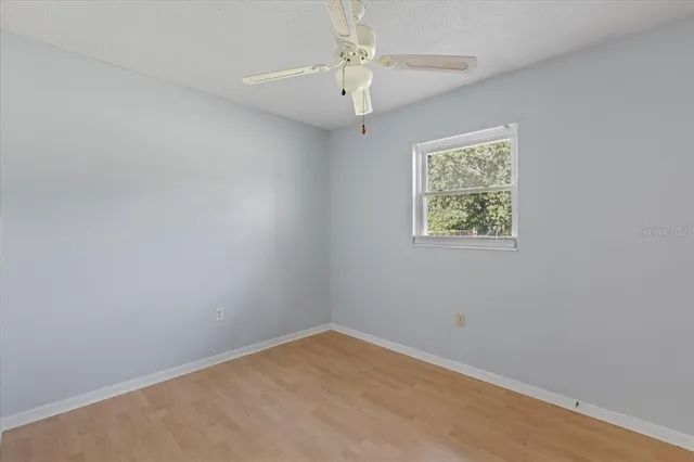 a kitchen with granite countertop white cabinets white appliances with a sink and dishwasher