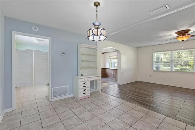 a hallway with cabinets and window