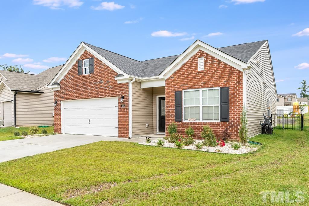 1505 Stark Spring Street Raleigh, NC 27610 - Photo 1 of 22 a front view of a house with a yard and garage