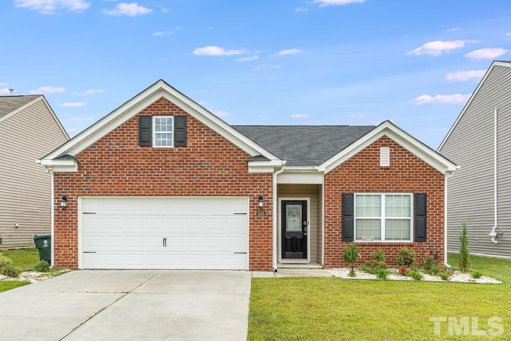 1505 Stark Spring Street Raleigh, NC 27610 - Photo 2 of 22 a front view of a house with a yard