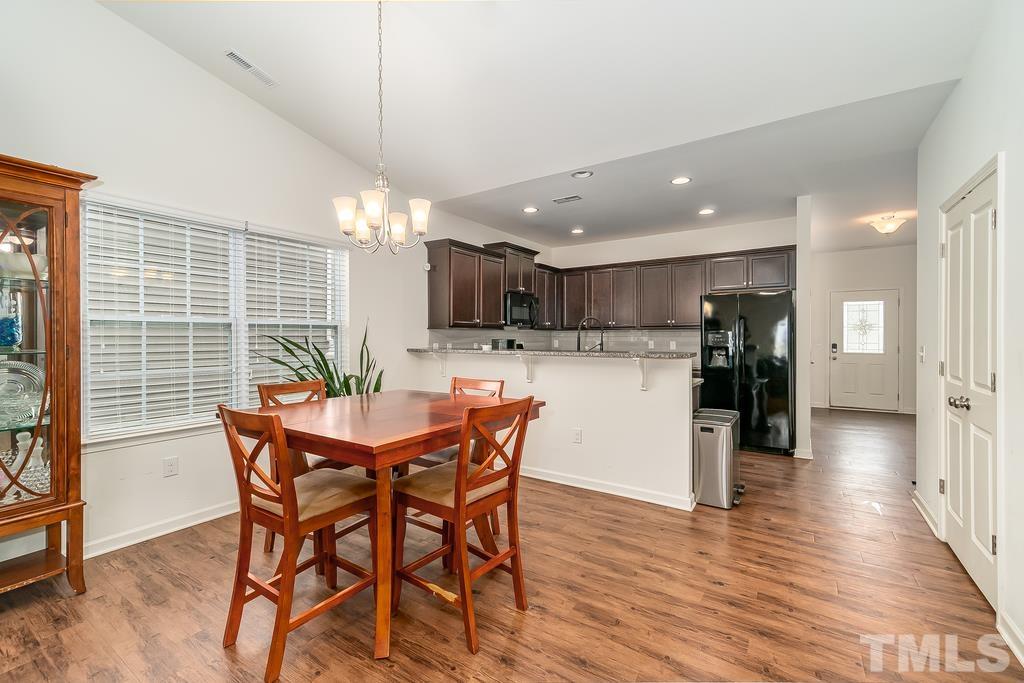 1505 Stark Spring Street Raleigh, NC 27610 - Photo 11 of 22 a dining room with furniture and wooden floor