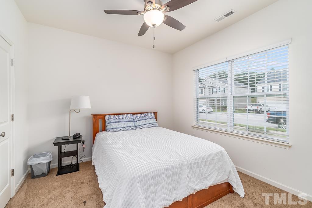 1505 Stark Spring Street Raleigh, NC 27610 - Photo 14 of 22 a bedroom with a bed and a large window
