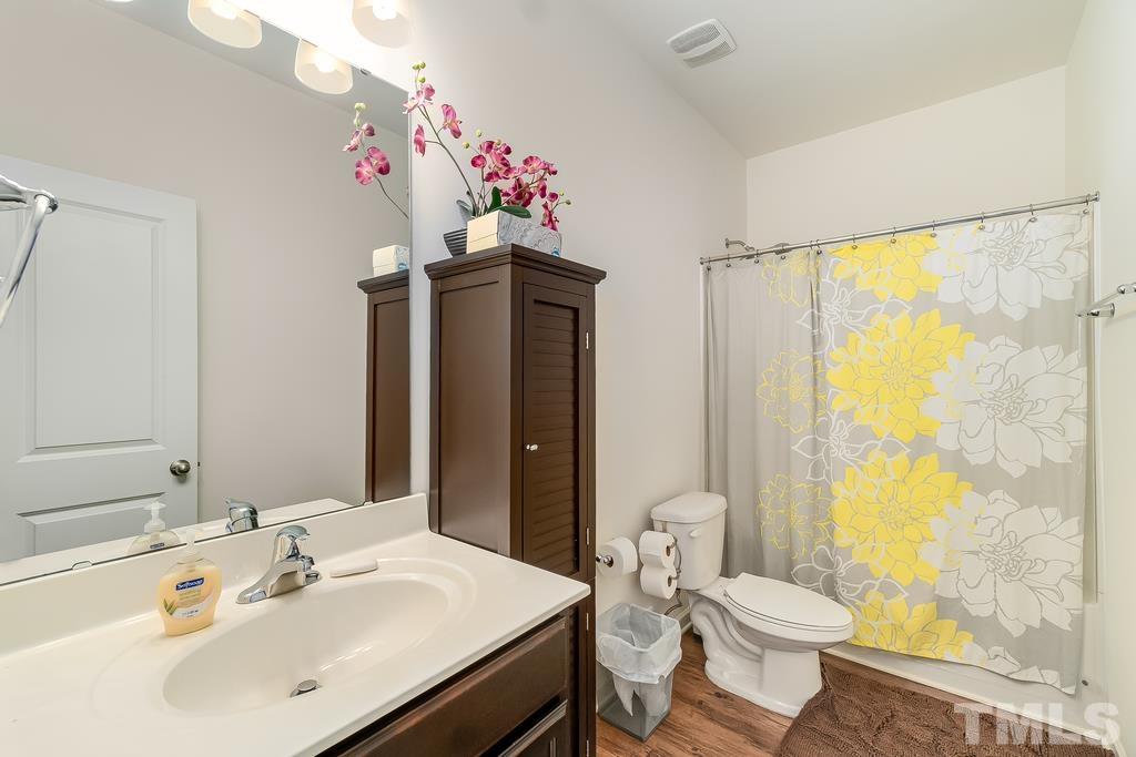 1505 Stark Spring Street Raleigh, NC 27610 - Photo 15 of 22 a bathroom with a sink toilet and shower