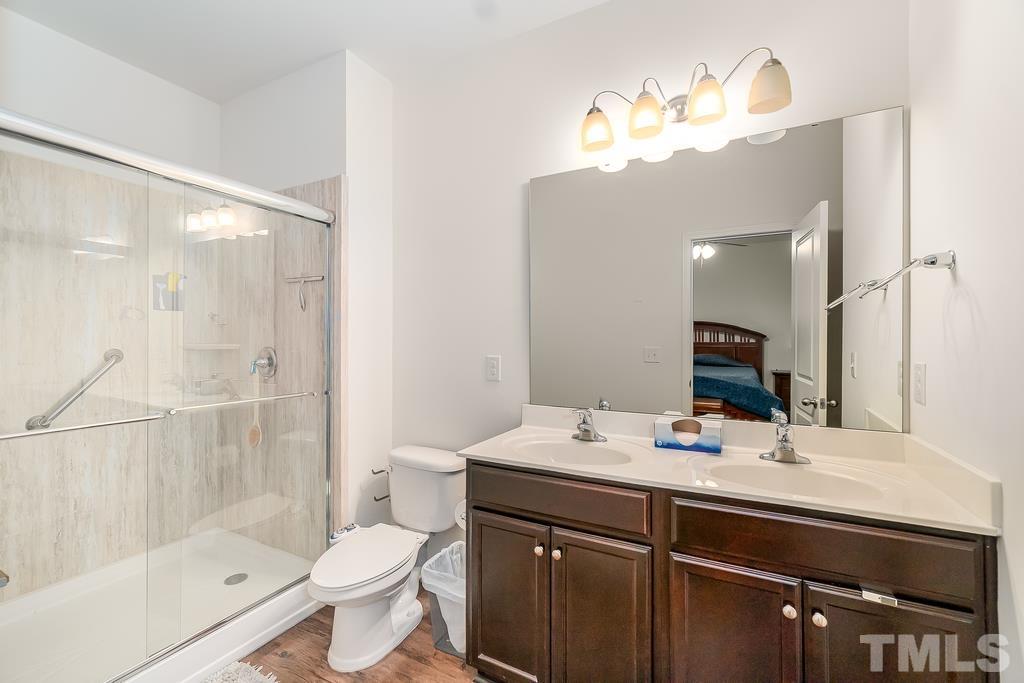 1505 Stark Spring Street Raleigh, NC 27610 - Photo 19 of 22 a bathroom with a sink a toilet and shower