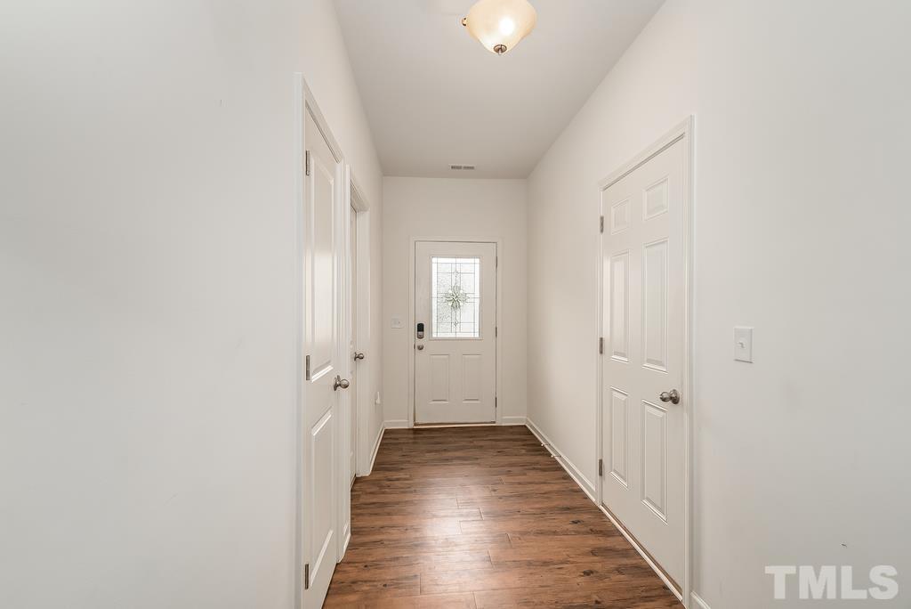 1505 Stark Spring Street Raleigh, NC 27610 - Photo 5 of 22 a view of a hallway with wooden floor