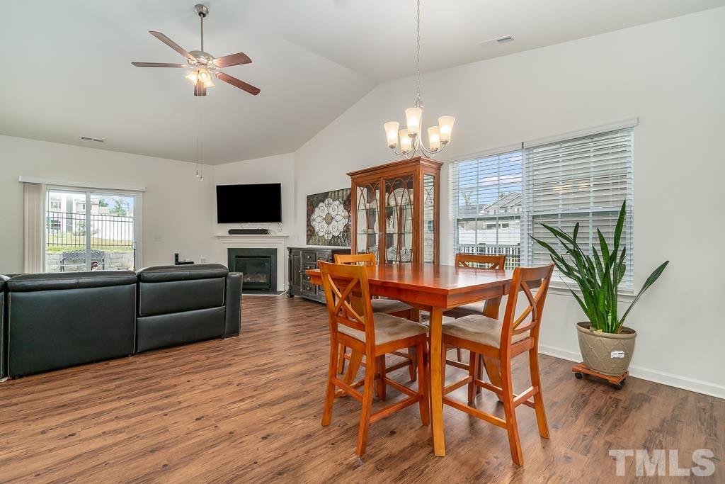 1505 Stark Spring Street Raleigh, NC 27610 - Photo 9 of 22 a dining room with furniture a chandelier and wooden floor