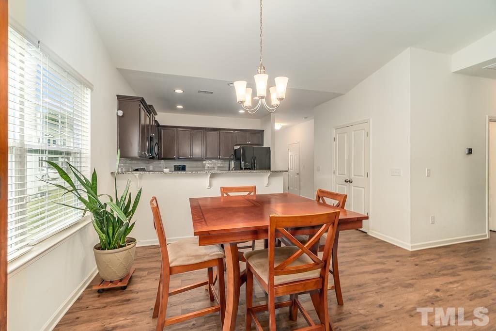 1505 Stark Spring Street Raleigh, NC 27610 - Photo 10 of 22 a view of a dining room with furniture window and wooden floor