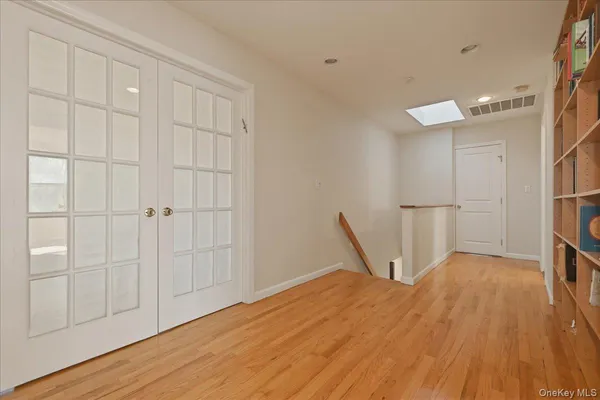 a view of a livingroom with wooden floor and closet