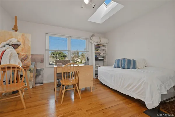 a white bath tub sitting next to a white sink and vanity