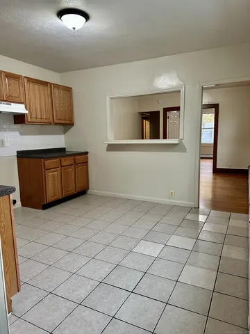 a view of a kitchen with granite countertop cabinets