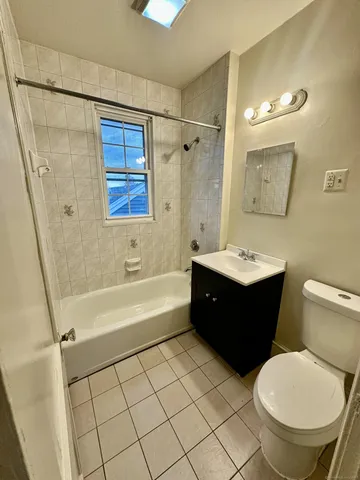 a bathroom with a sink a toilet and bathtub