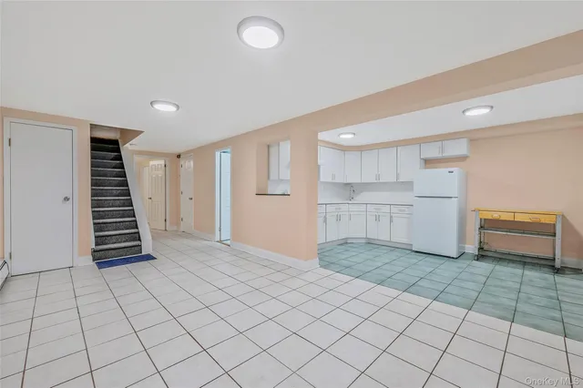 a view of a kitchen with white cabinets