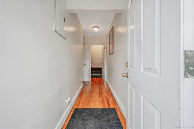 a view of a hallway with wooden floor
