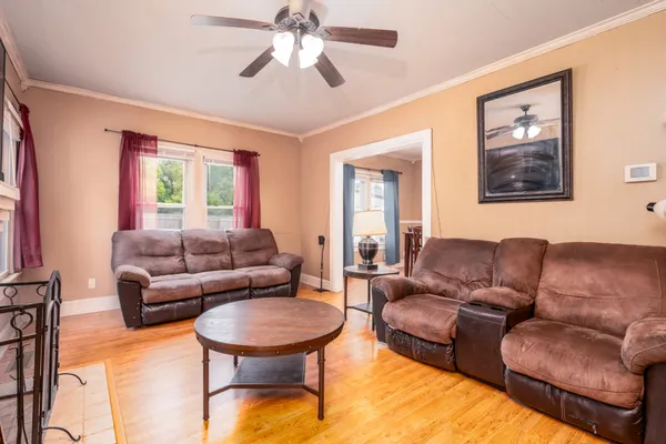 a living room with furniture and a wooden floor