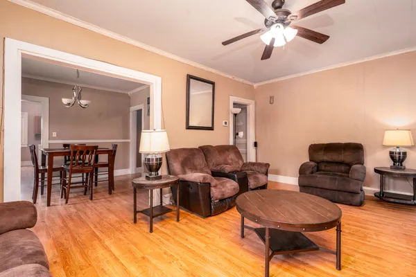 a view of a dining room with furniture wooden floor and chandelier