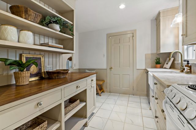 a kitchen with stainless steel appliances a sink and cabinets