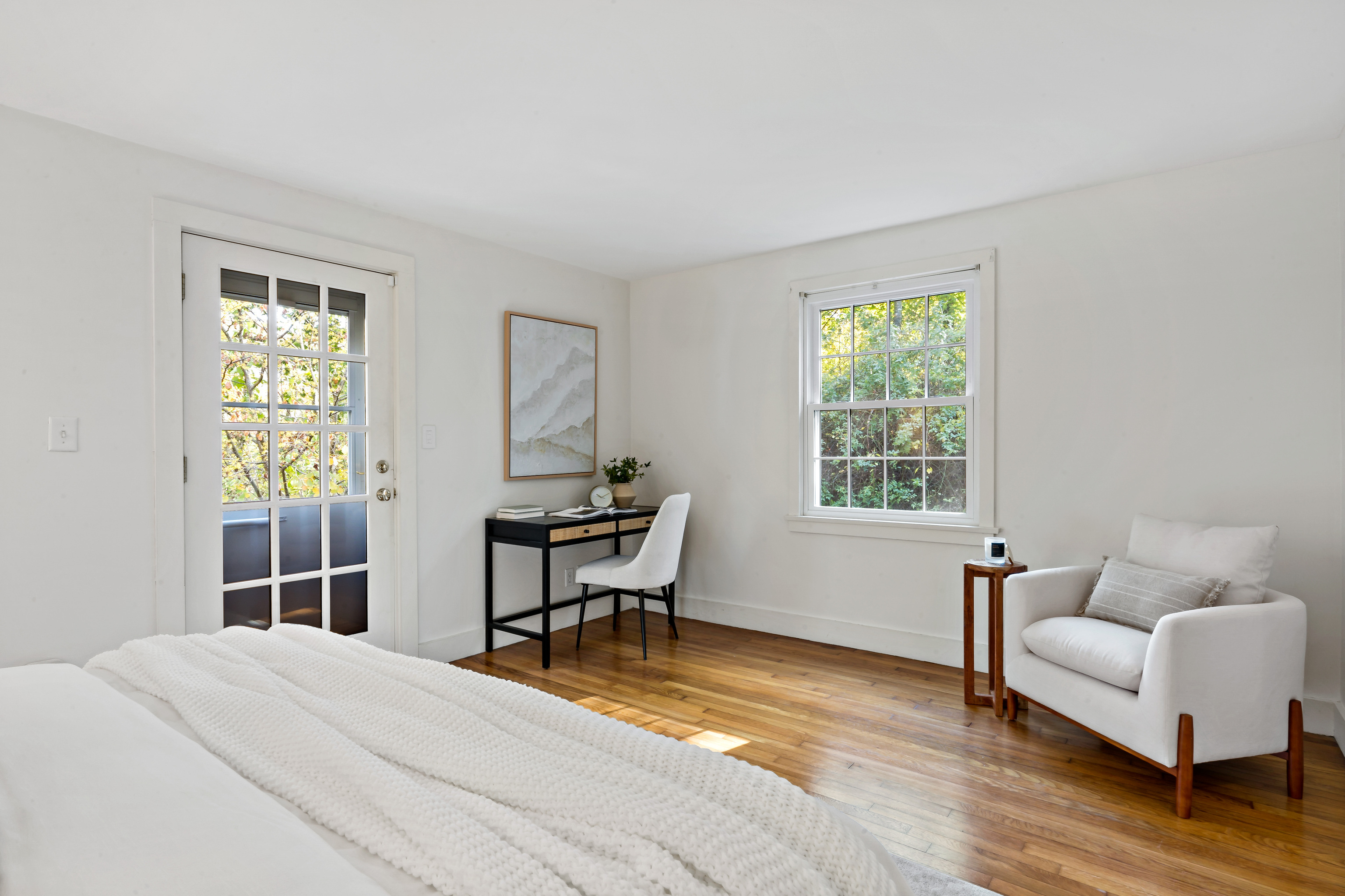 12 Flanders Road Stonington, CT 06378 - Photo 16 of 36 a bedroom with a bed and a couch next to a window