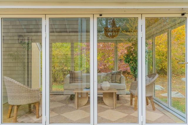 a balcony with furniture and a potted plant