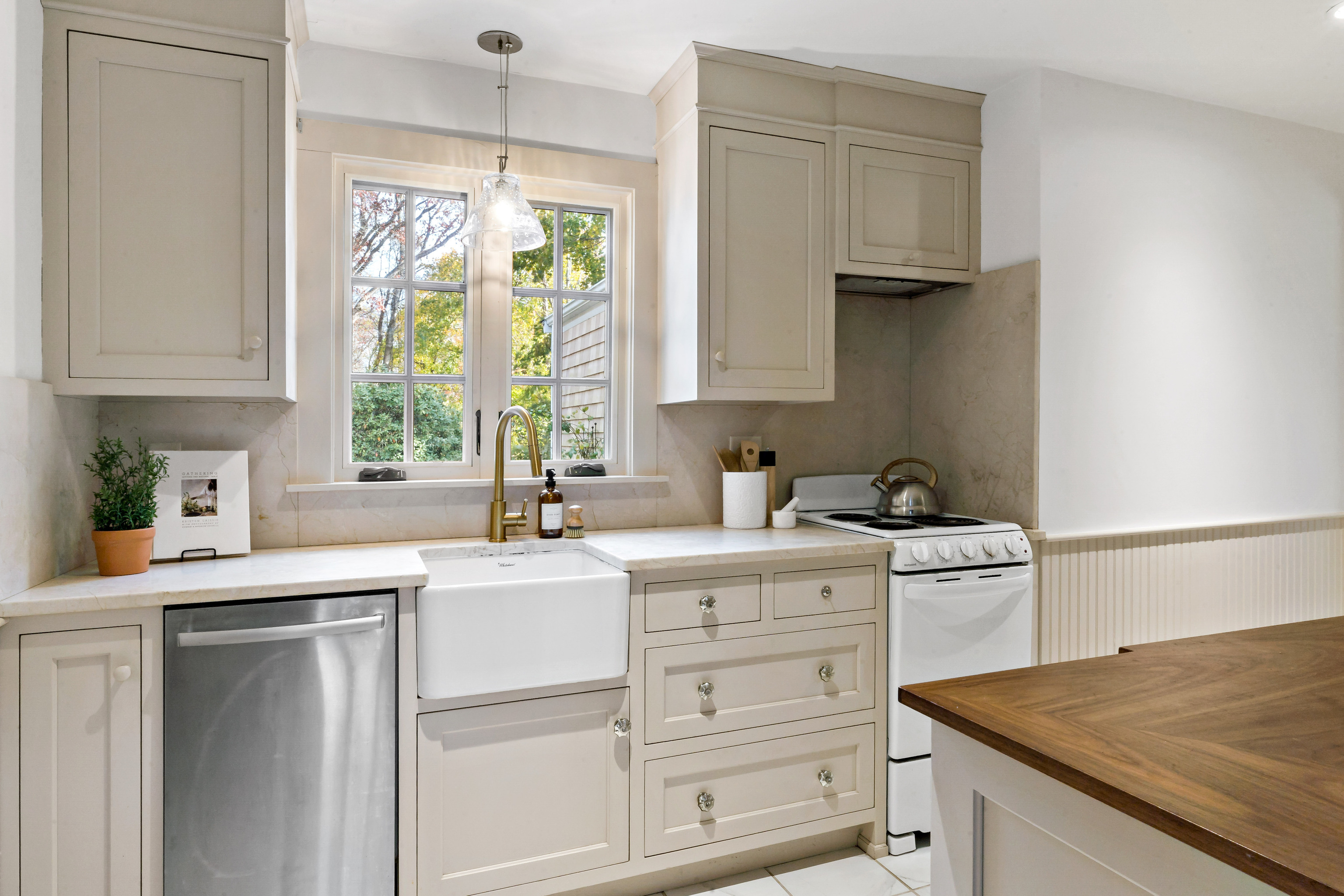 12 Flanders Road Stonington, CT 06378 - Photo 9 of 36 a kitchen with a stove a sink and a window