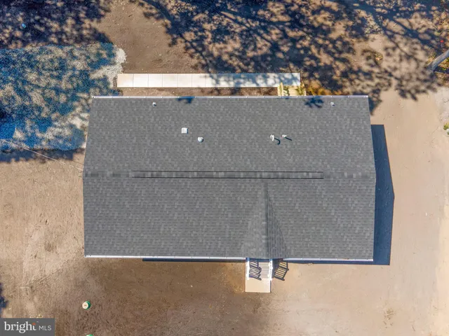 an aerial view of a house with parking space