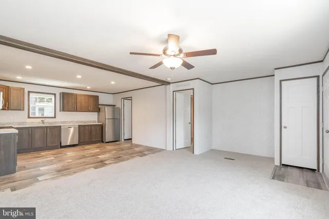 a view of a kitchen with a sink and a refrigerator