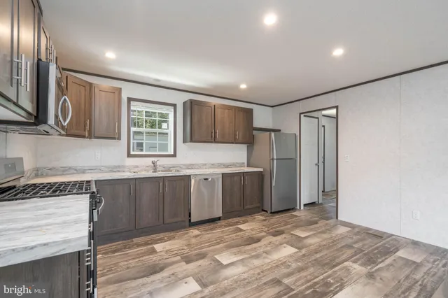 a kitchen with granite countertop cabinets and window