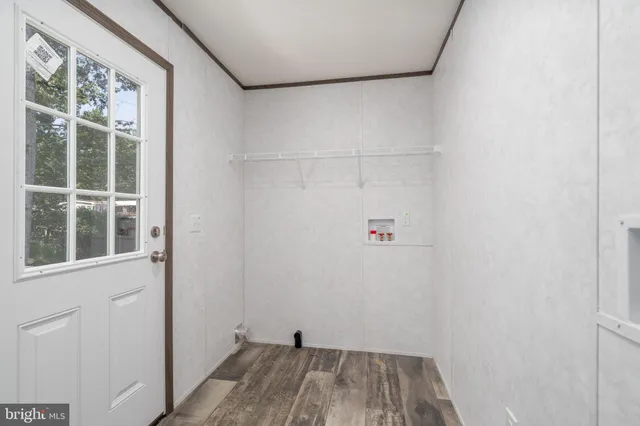 a view of a small space with wooden floor and a window